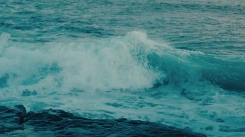 Turquoise Wave Curling and Breaking into Whitewater Rolling Toward Rocky Shore Stock Footage 342601807