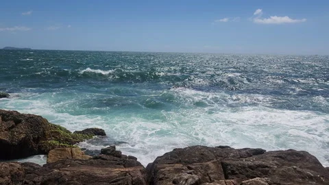 Turquoise Waves and White Sea Foam Crashing on Coastal Rocks Stock Footage 327227663