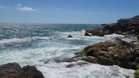 Turquoise Waves and White Sea Foam Crashing on Coastal Rocks Stock Footage 327227776