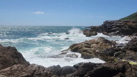 Turquoise Waves and White Sea Foam Crashing on Coastal Rocks Stock Footage 327228062