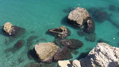 Turquoise waves around cliffs at Spanish coast Stock Footage 140604098