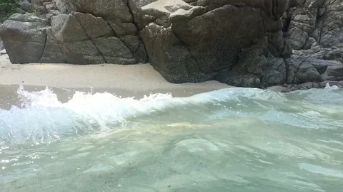 Turquoise waves crashing on a rock Stock Footage 103550348