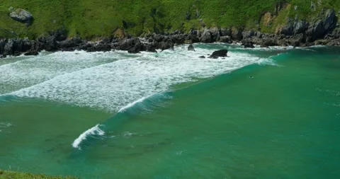 Turquoise waves gently lap against a sandy beach. Vídeos de archivo 343672025