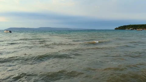 Turquoise waves lap against a pristine Stock Footage 276602334