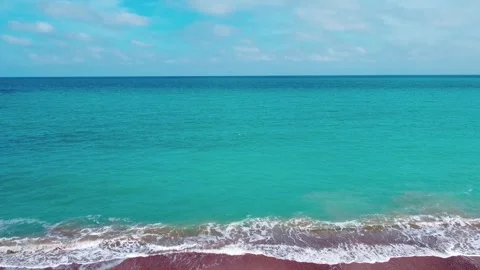 Turquoise waves rolling on the beach Stock Footage 309571173