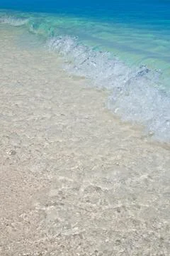 Turquoise waves on the sandy beach Stock Photos