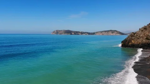 Turquoise Waves splashing,flying back Overflight Along natural rocky Coastline Video stock 105243893