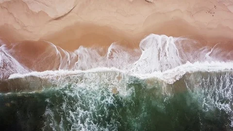Turquoise waves with white foam covers empty beach Stock Footage 118864995