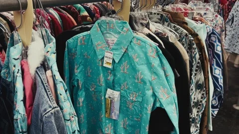 Turquoise western shirt with cactus pattern on clothing rack Stock Footage 316061273