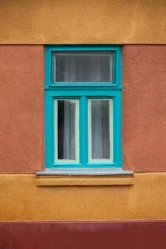 Turquoise window on a painted wall Stock Photos