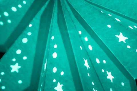 Turquoise xmas lantern star pattern at christmas market season. Shiny star mo Foto stock