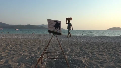 Turtle nest cage and a beach seller of simit Stock Footage 137362836