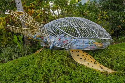 A turtle-shaped trash can that functions to collect plastic waste on the beac Stock Photos