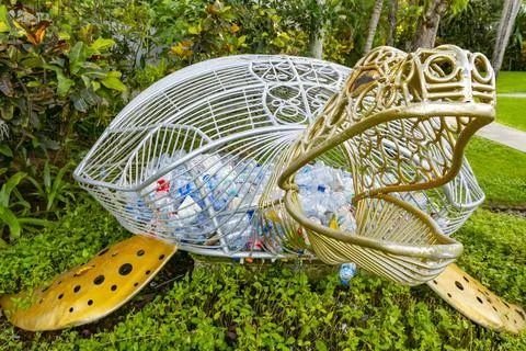 A turtle-shaped trash can that functions to collect plastic waste on the beac Stock Photos