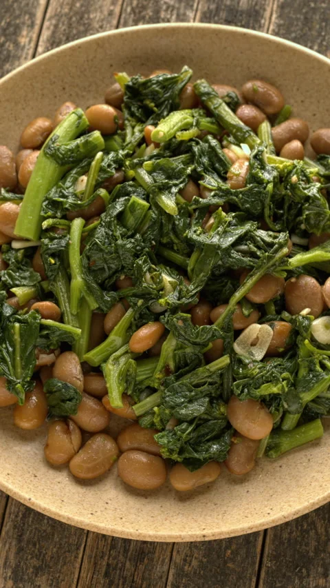 Tuscan butter beans stew with rapini and garlic rotating flat lay top view. Stock Footage 342276272