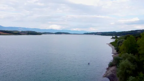 Tuscan lake under changing sky seen from above Stock Footage 320850382