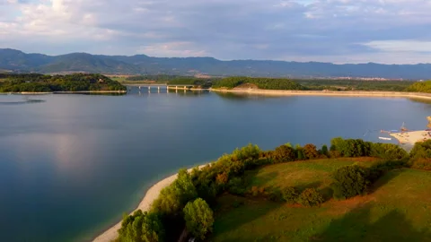 Tuscan lake under passing clouds and sunshine Stock Footage 320849508