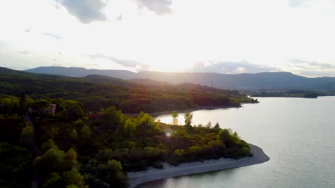 Tuscany lake with clouds rolling over sunlight Stock Footage 320860539