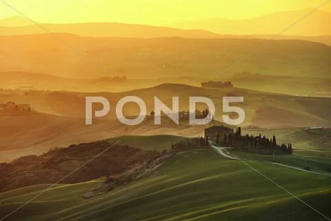 Tuscany spring, rolling hills on misty sunset. Rural landscape. Green fields Stock Photos