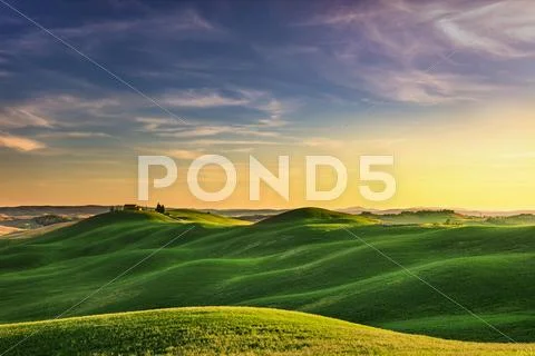Tuscany, sunset rural landscape. Rolling hills, countryside farm, trees. Stock Photos