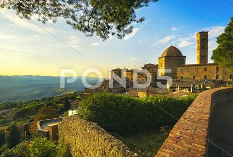 Tuscany, Volterra town skyline, church and trees on sunset. Italy Stock Photos