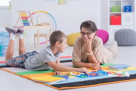 Tutor and child learning together Stock Photos