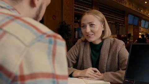 Tutor and student smiling during a friendly learning discussion in a cafe Stock Photos