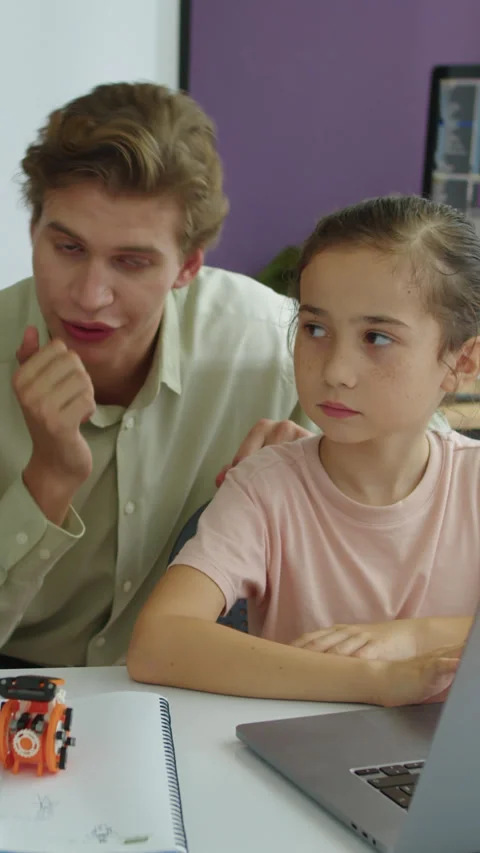 Tutor Explaining Task to Students on Laptop during Developing Class Stock Footage 280638507