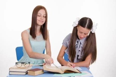 Tutor explains the girl move solving Stock Photos