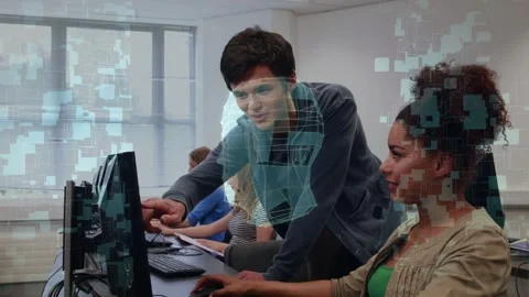 Tutor leaning over workstation, pointing at monitor and reviewing 3D skull Stock Footage 334338014