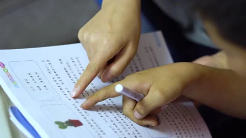 Tutor pupils to read aloud and do homework after class Stock Footage 164633340