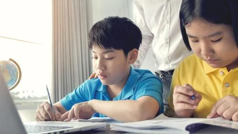 Tutor room children in class learning on laptop computer Stock Photos