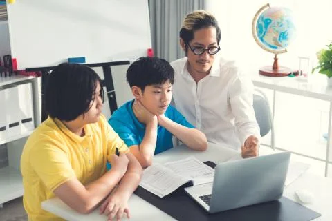 Tutor room children in class learning on laptop computer Stock Photos