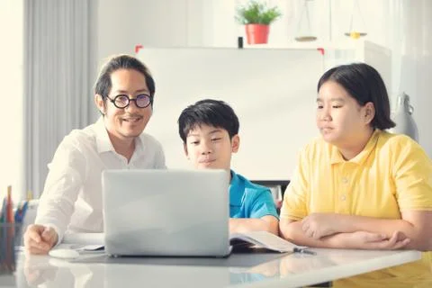 Tutor room children in class learning on laptop computer Foto stock