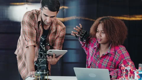 A tutor supports a student in building a robotic arm for design and technology Stock Footage 275534103