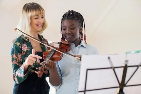 Tutor Teaching High School Student To Play Violin In Music Lesson Stock Photos