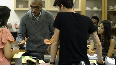 Tutor teaching students using anatomical model, looking at camera smiling. 스톡 동영상 88015287