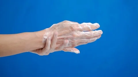 Tutorial, how to wash your hands with soap. closeup on blue background Stock Footage 126771525