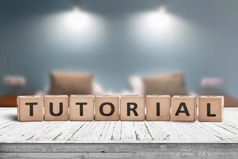 Tutorial sign on a wooden table in a room with lights Stock Photos