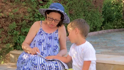 Tutoring concept. Preschooler having classes at home. Grandmother teaching Stock Footage 130259778