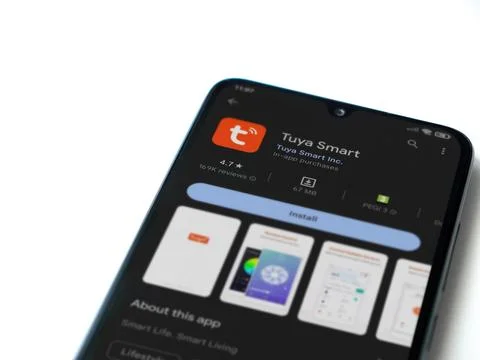 Tuya Smart app play store page on smartphone on white background Stock Photos