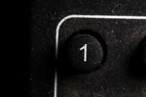 Tv 1 icon and button close up of a old dusty black Television remote controll Stock Photos
