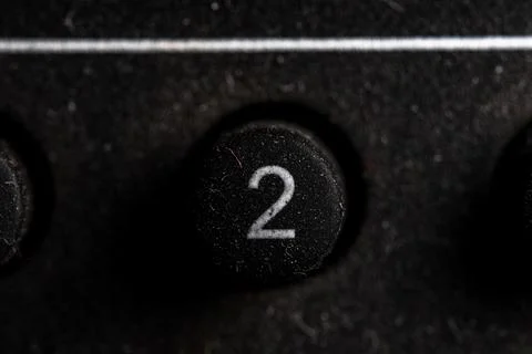Tv 2 icon and button close up of a old dusty black Television remote controll Stock Photos