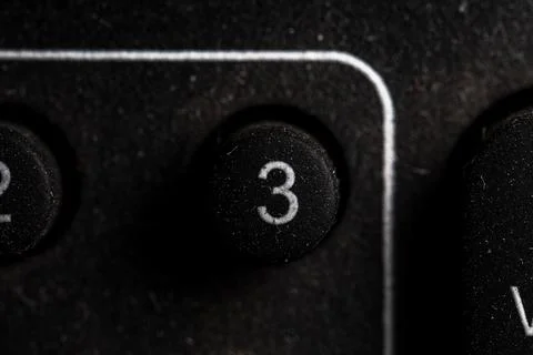 Tv 3 icon and button close up of a old dusty black Television remote controll Stock Photos