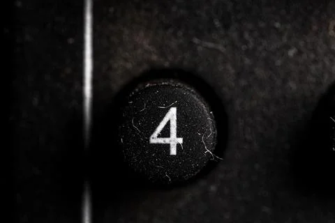 Tv 4 icon and button close up of a old dusty black Television remote controll Stock Photos