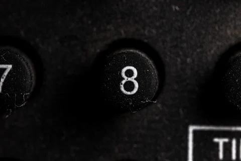 Tv 8 icon and button close up of a old dusty black Television remote controll Stock Photos