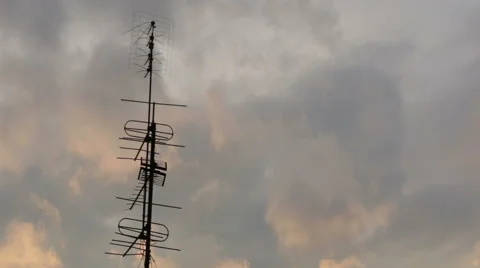 TV antenna in the clouds at sunset Stock Footage 49240003