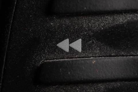 Tv backward icon and button close up of a old black Television remote contr.. Stock-Fotos