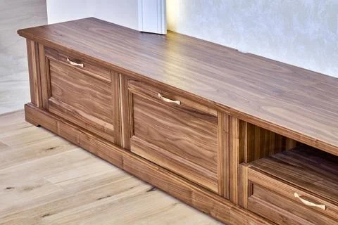 TV cabinet of veneer and solid walnut Stock Photos