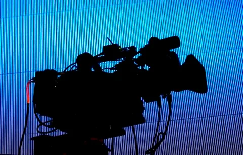 Tv camera in a concert hal. Professional digital video camera. Stock Photos